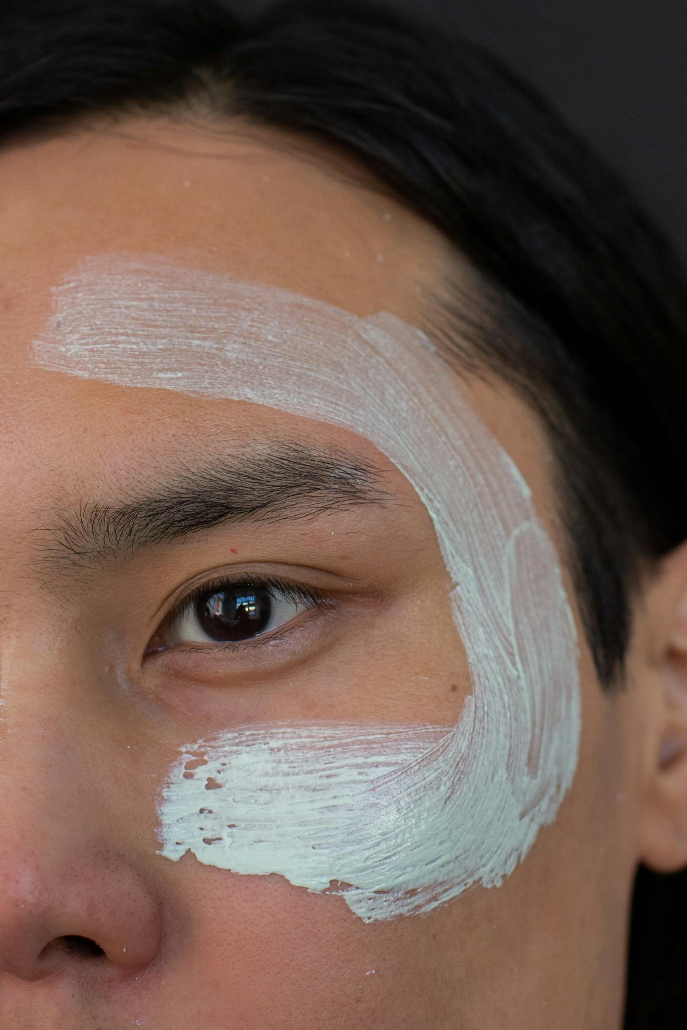 Anonymous Asian man with natural sensitive skin routine facial mask 