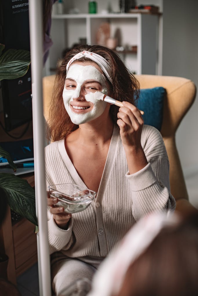 Smiling Woman Applying a Homemade Clay Face Masks