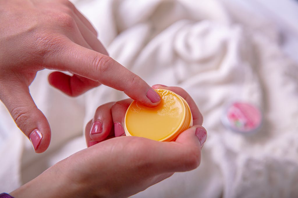 Hand of a Woman using Citrus Burst SPF Balm