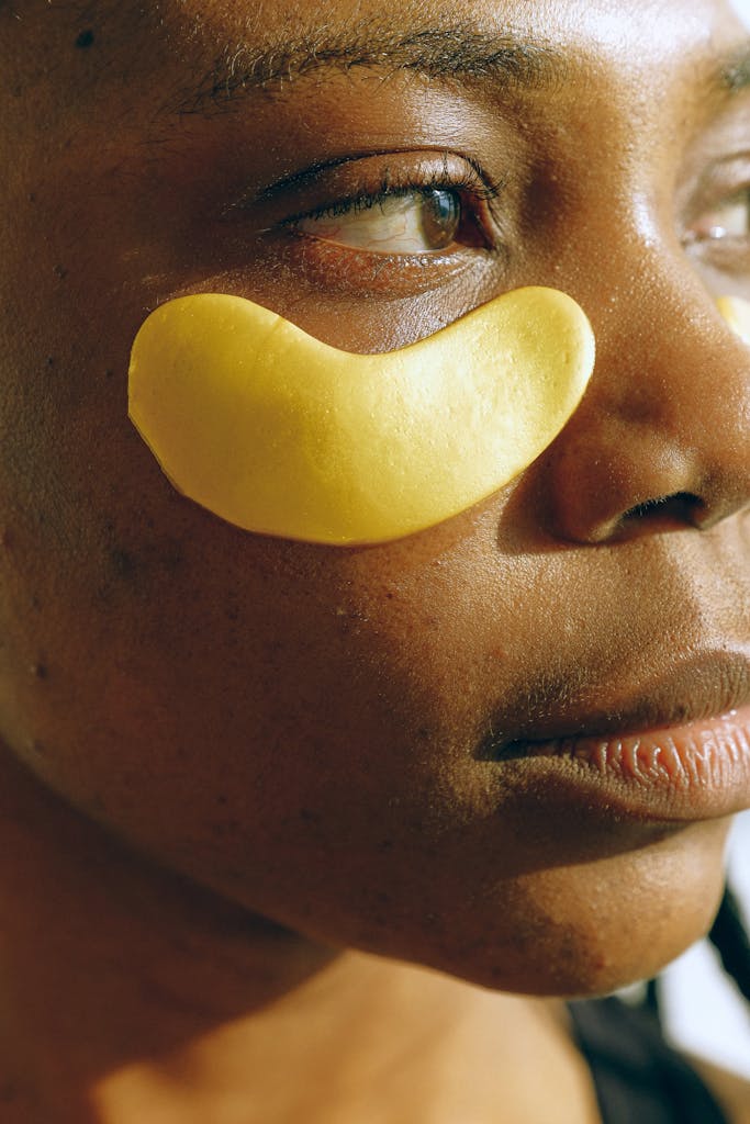 Young black woman applying natural dark circle remedies