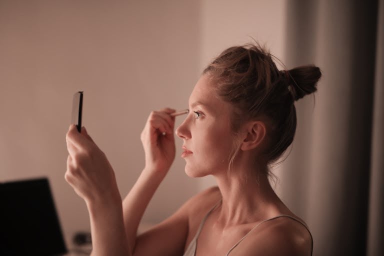 Woman Putting Makeup on Face